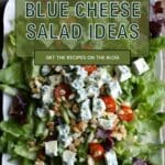 A photo of a white plate topped with a salad made with mixed greens, crumbled blue cheese, cherry tomatoes, and walnuts.
