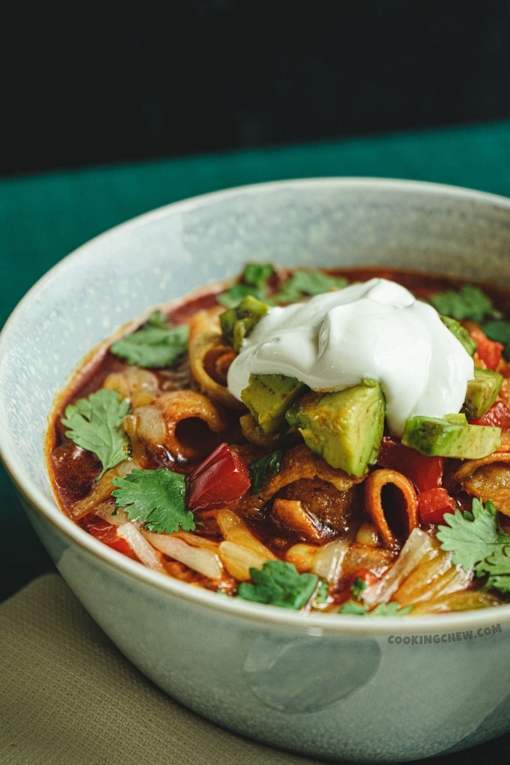 A close-up photo of a hearty and flavorful taco soup, ready to warm you up from the inside out. 