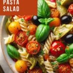 A close-up photo of a Mediterranean-style pasta salad with fresh vegetables and herbs.