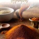A pile of creole seasoning mix is being poured onto a brown wooden table.