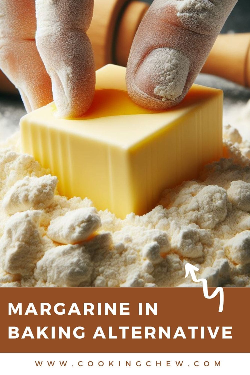 A close-up photo of a hand holding a stick of margarine on top of a pile of flour.