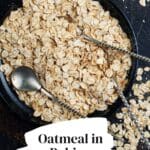 A photo of a bowl of oatmeal with a spoon in it.