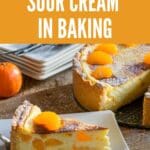 Fresh baked tangerine sour cream cake on a plate on a rustic wooden board.
