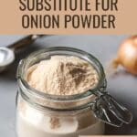 A glass jar of onion powder stands on a wooden table.