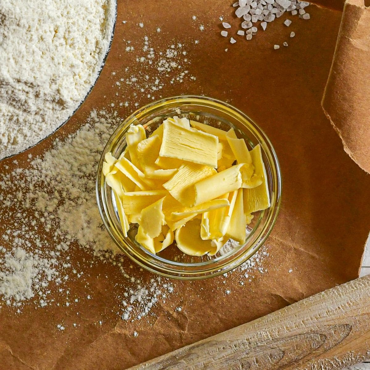 A close-up photo of a bowl of cubed margarine on a table.