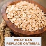 A wooden bowl filled with rolled oats sits on a wooden table.