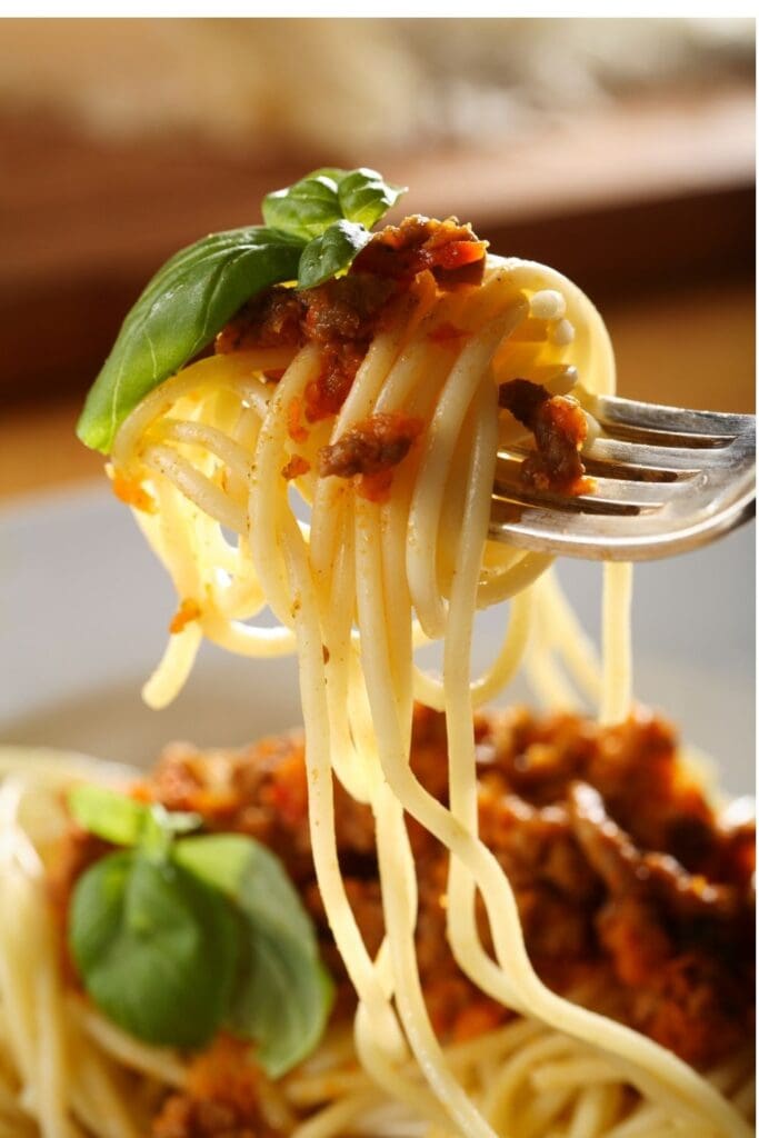 Spaghetti with meat sauce twirled on a fork.