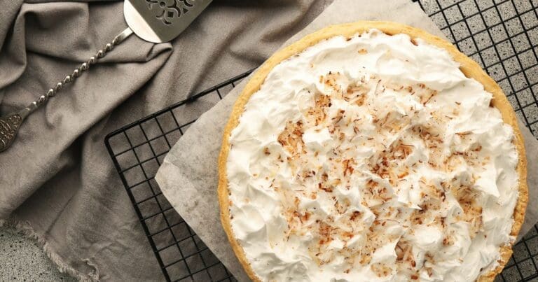 Cooked coconut cream pie on a wire cooling rack