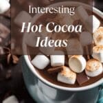 A classic and comforting cup of hot cocoa, adorned with melted marshmallows and aromatic cinnamon sticks.