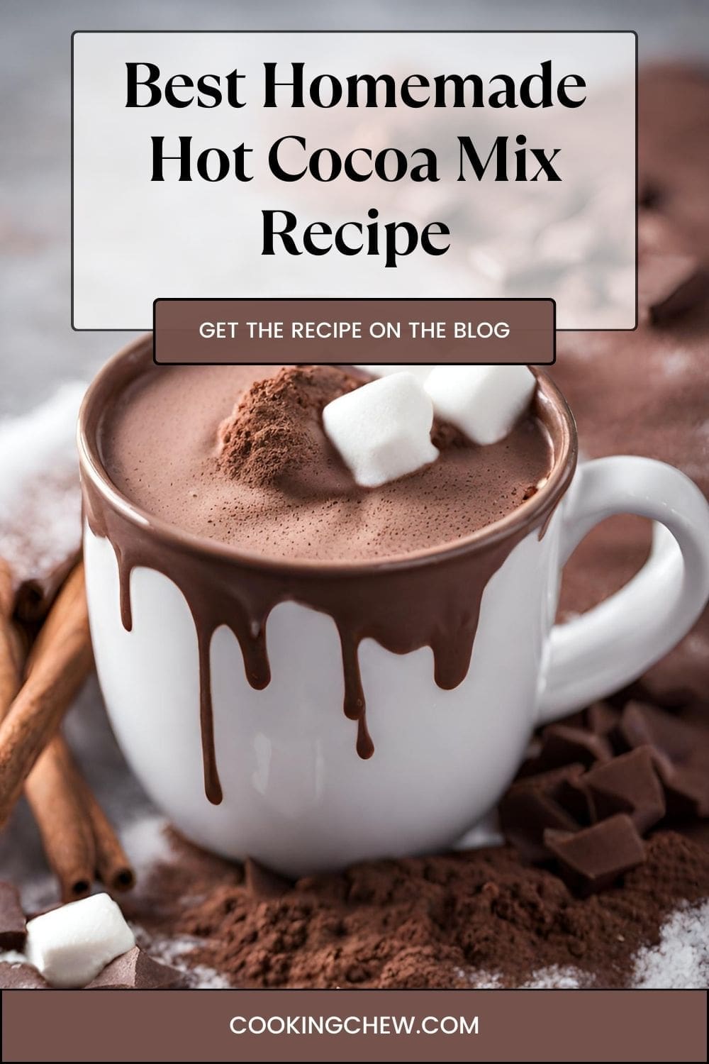 A cup of hot chocolate with marshmallows and a cinnamon stick on a table.