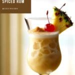 A photo of a refreshing spiced rum painkiller drink in a tall glass.