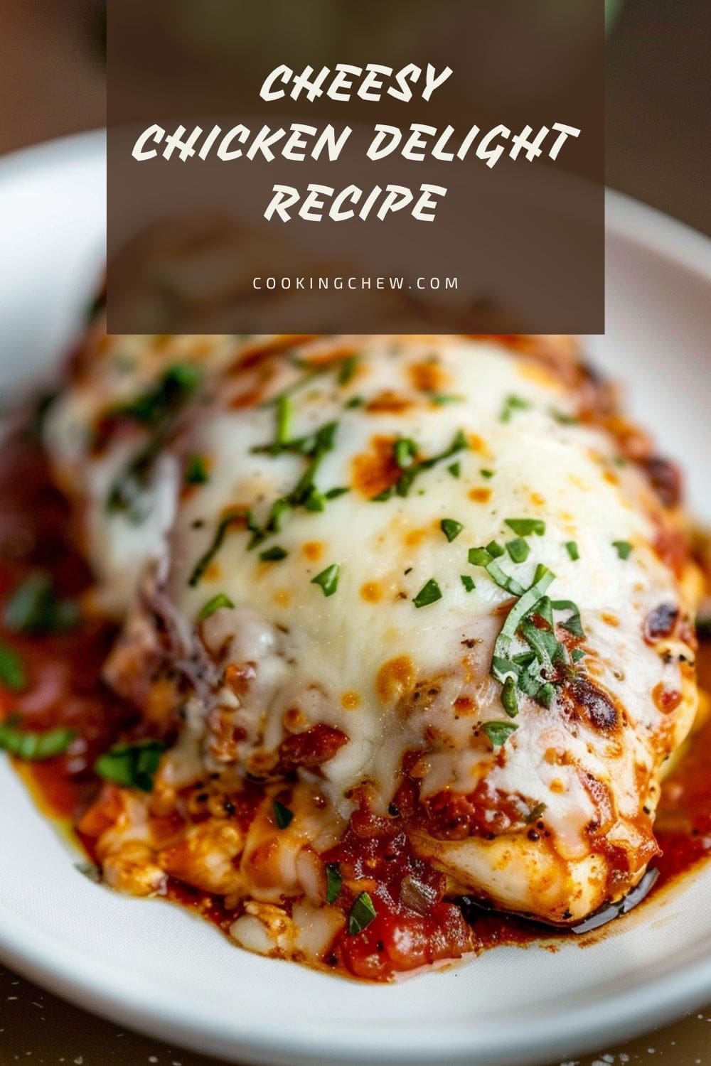 A white plate with a boneless, skinless chicken breast topped with melted mozzarella cheese and a red sauce.