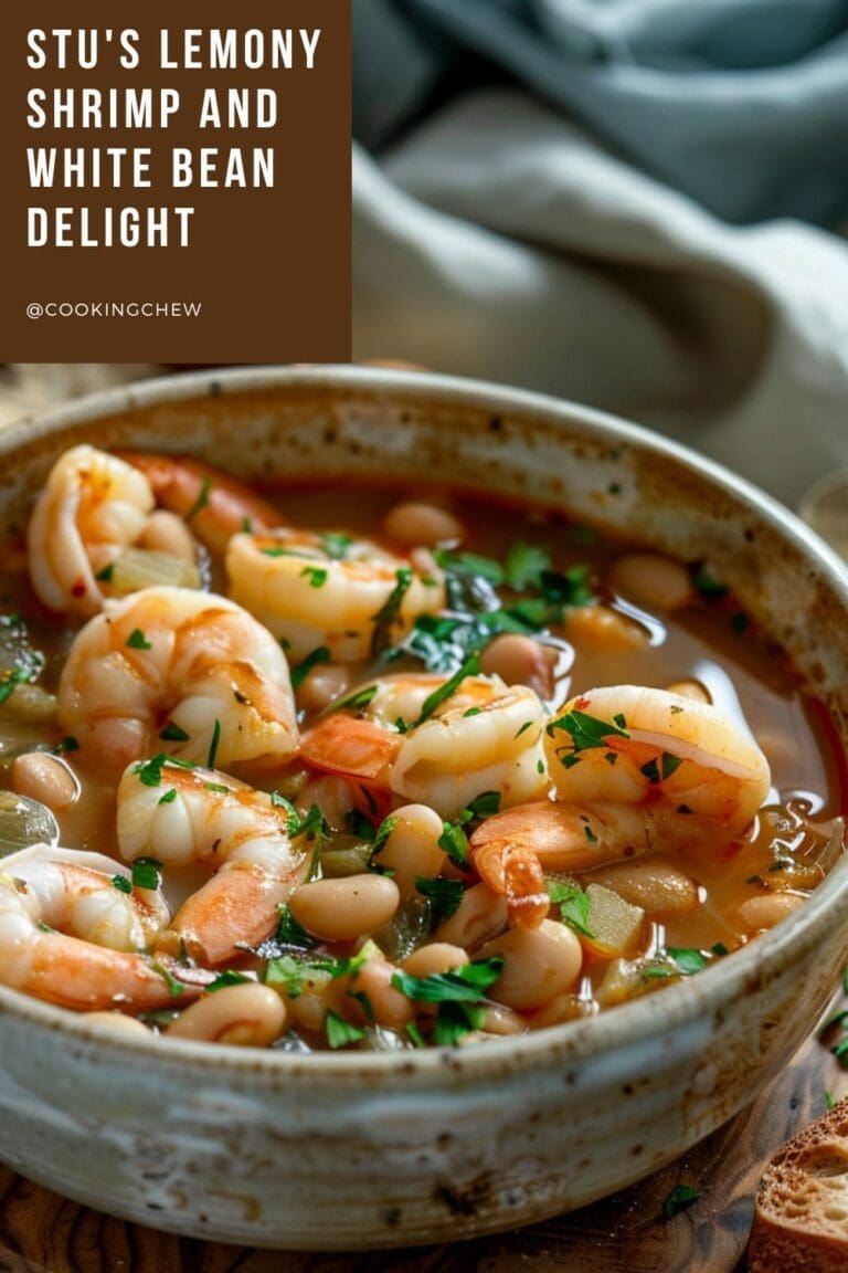 A white bowl filled with lemony shrimp and white bean soup sits on a wooden table.