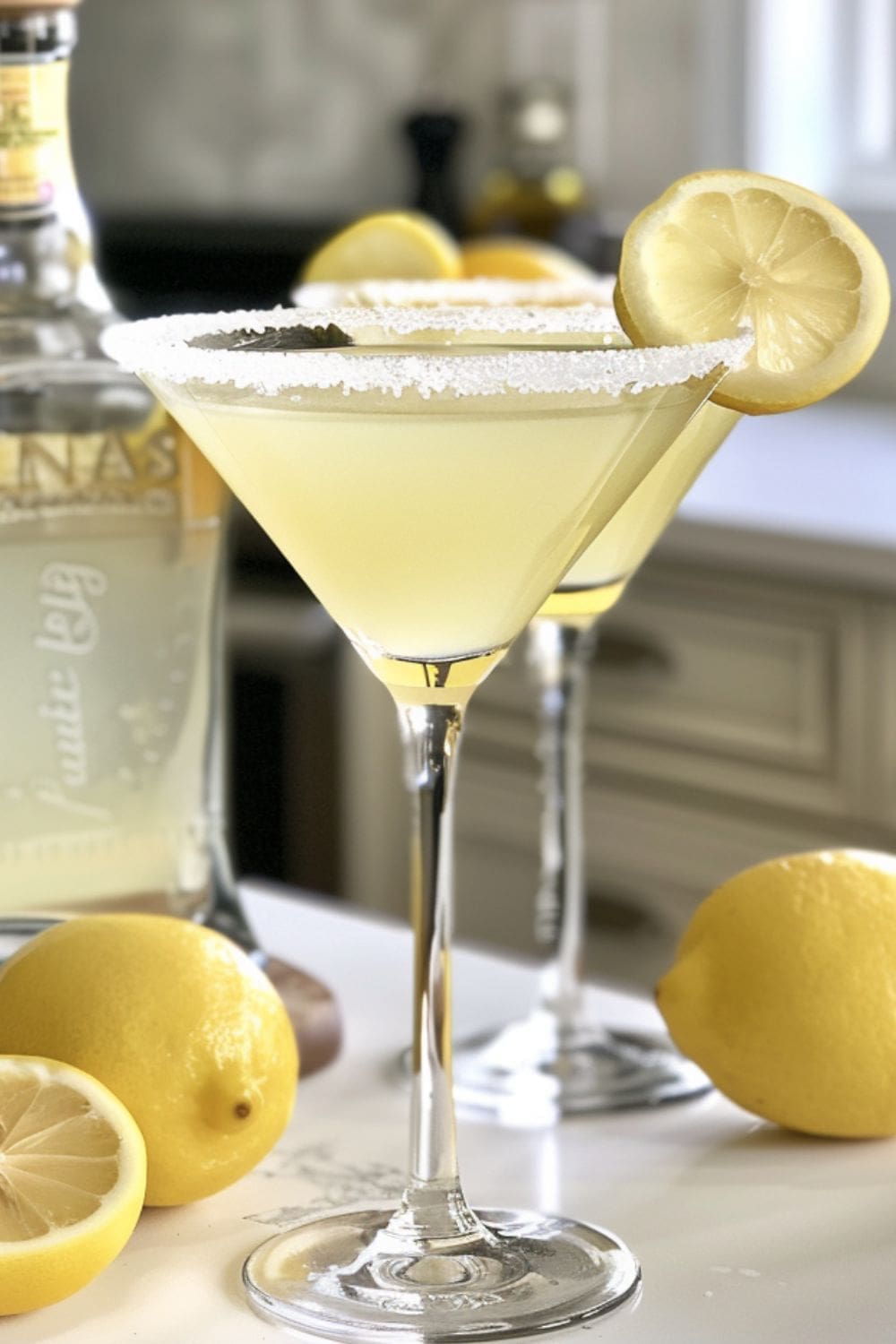 A close-up of a martini glass filled with a lemon drop martini. 