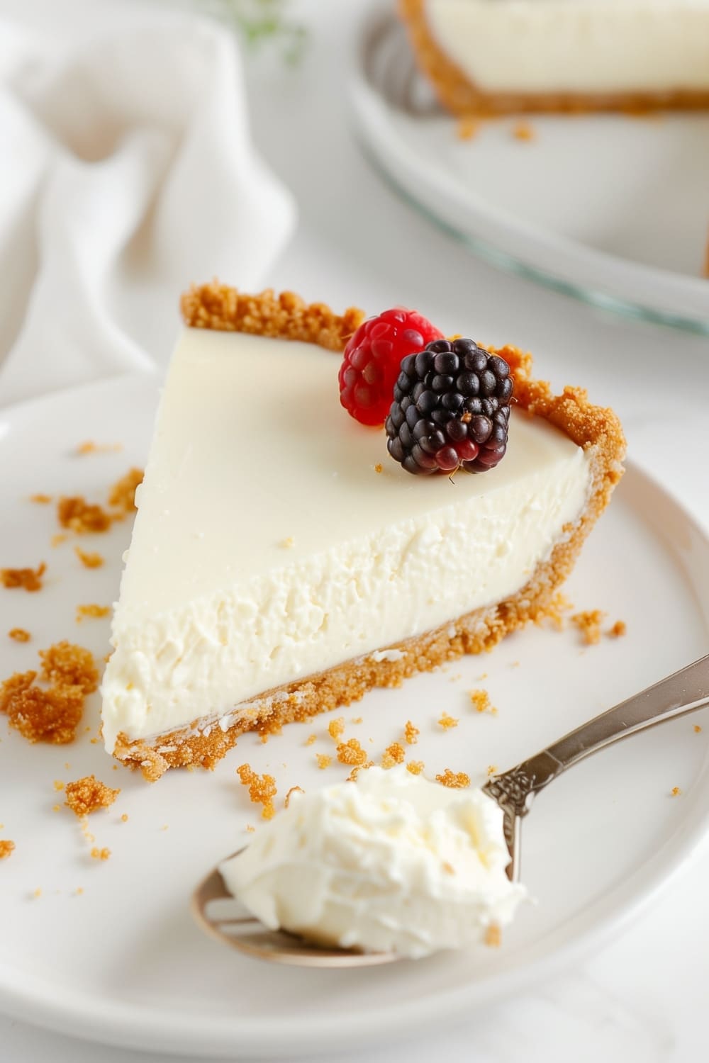 A smooth and creamy no bake cheesecake with a graham cracker crust, topped with fresh berries. Perfect for a quick and easy dessert.