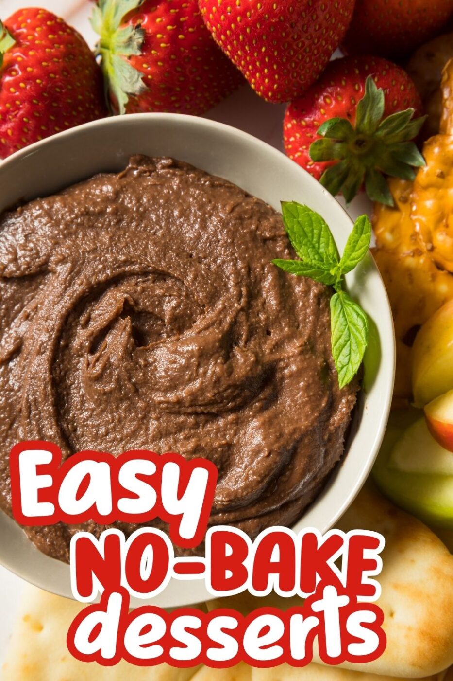 A bowl of dark brown chocolate hummus, a combination of blended chick peas, high quality cocoa powder and sugar with whole strawberries for dipping.
