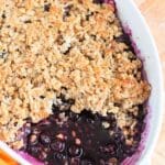 A freshly baked blueberry maple crisp with a golden crumble topping, perfect for dessert.