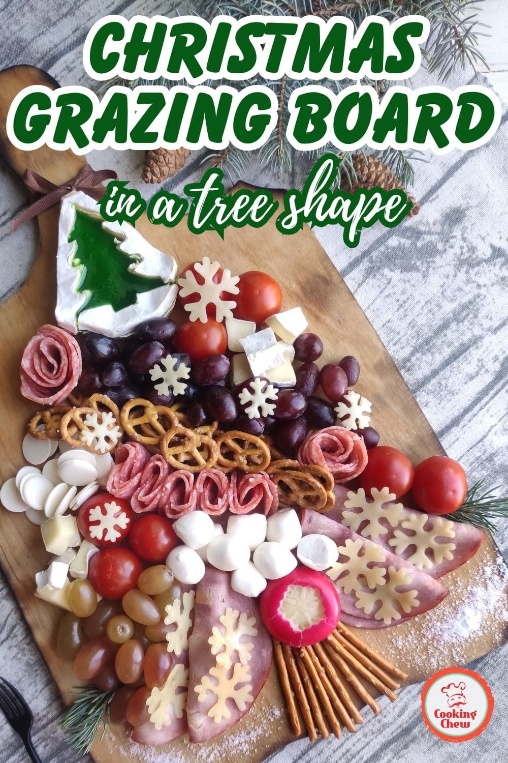 Holiday grazing board shaped like a Christmas tree with festive snacks