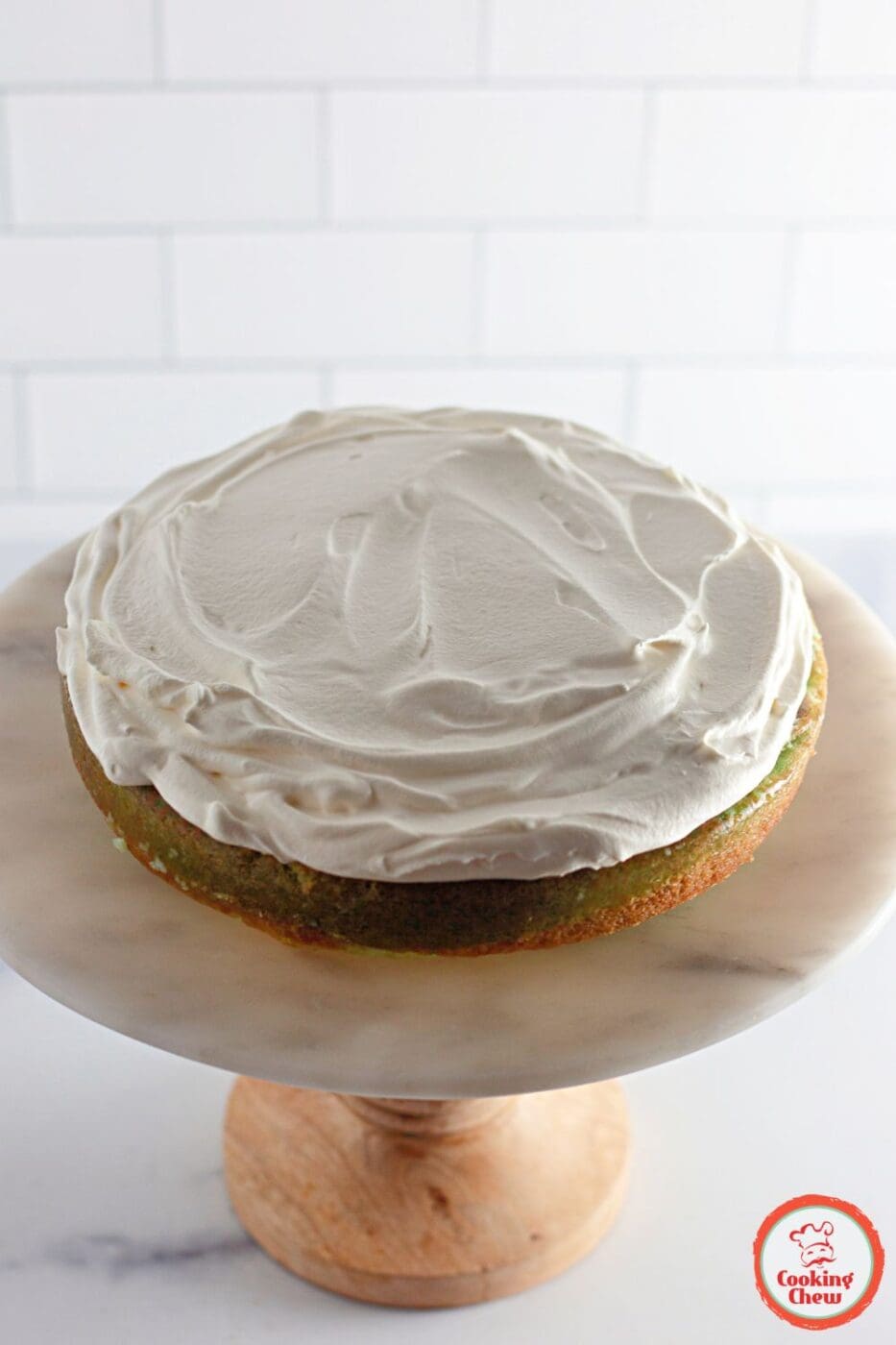 Brightly colored layered Jello cake served on a holiday-themed plate.