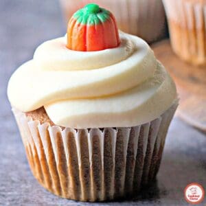 Fall pumpkin cupcakes topped with fluffy cream cheese frosting.