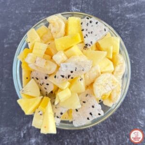 Festive white fruit salad with seasonal winter fruits for holiday brunch.