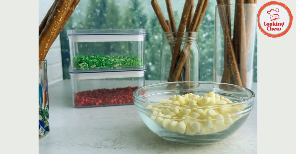 Festive chocolate-dipped pretzel rods decorated with holiday sprinkles.