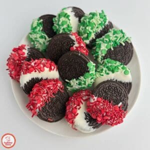 Holiday-themed chocolate-covered Oreos on a festive platter.