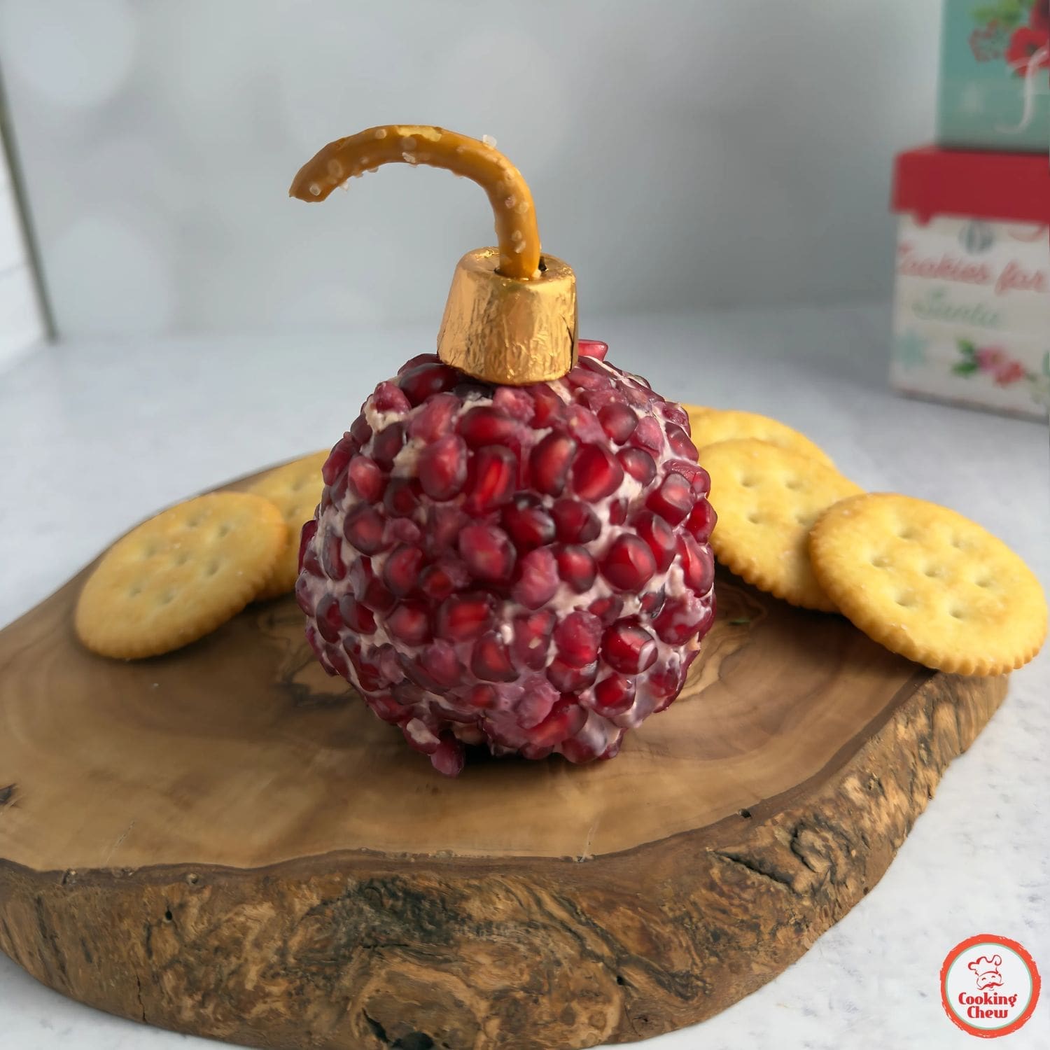 A festive cheese ball with pomegranate seeds for Christmas parties.