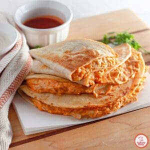 A golden-brown quesadilla stuffed with buffalo chicken and melted cheese.