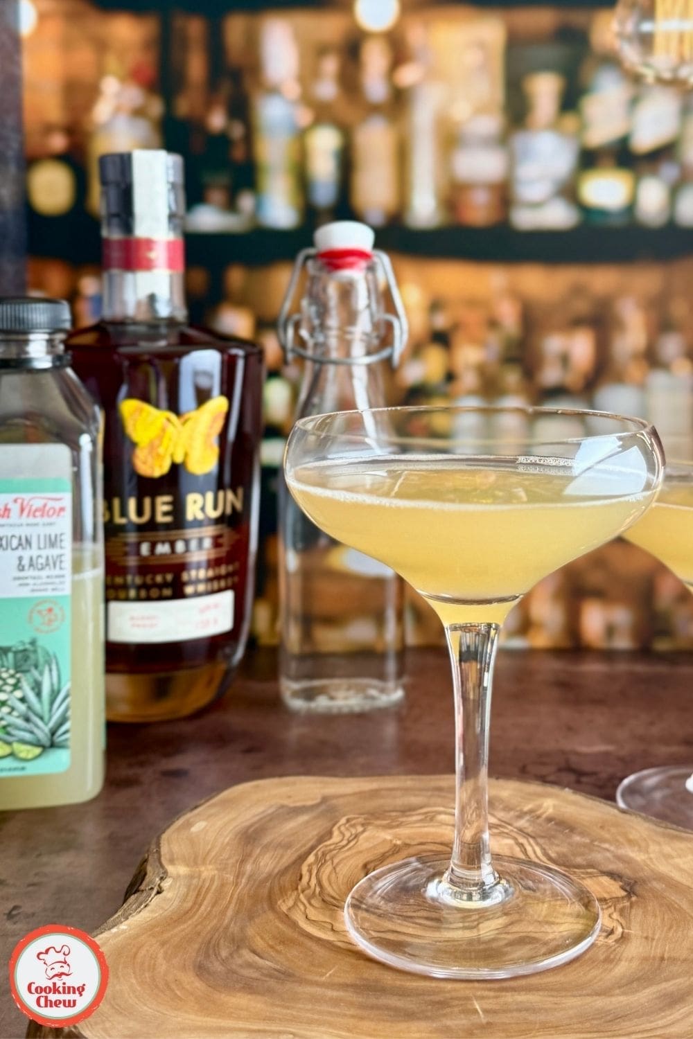 A Bourbon Lime Sour cocktail served in a chilled glass with a lime garnish and ice cubes.