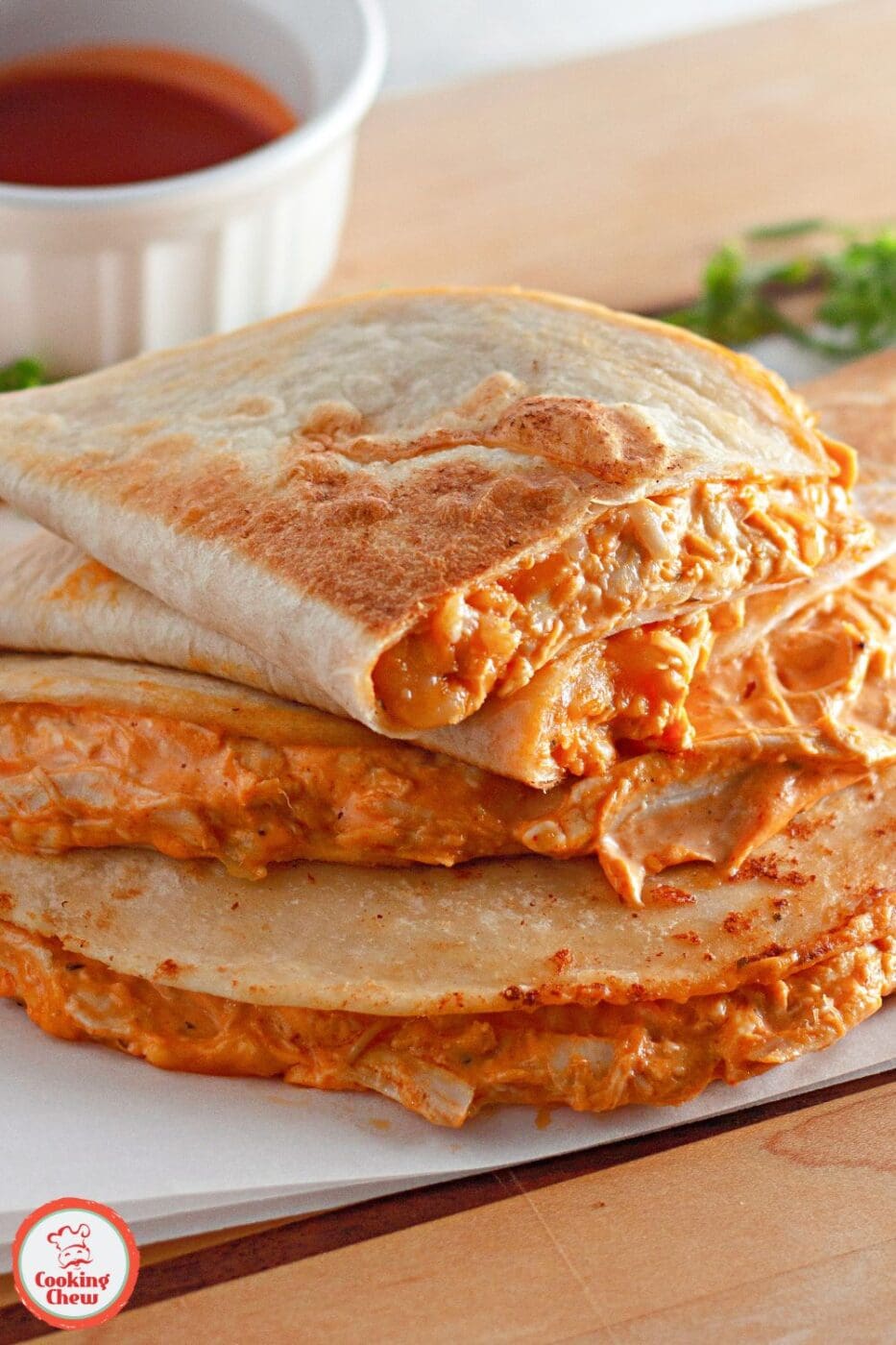 Golden, crispy buffalo chicken quesadillas filled with melted cheese and spicy buffalo sauce, cut into triangles and served with ranch.