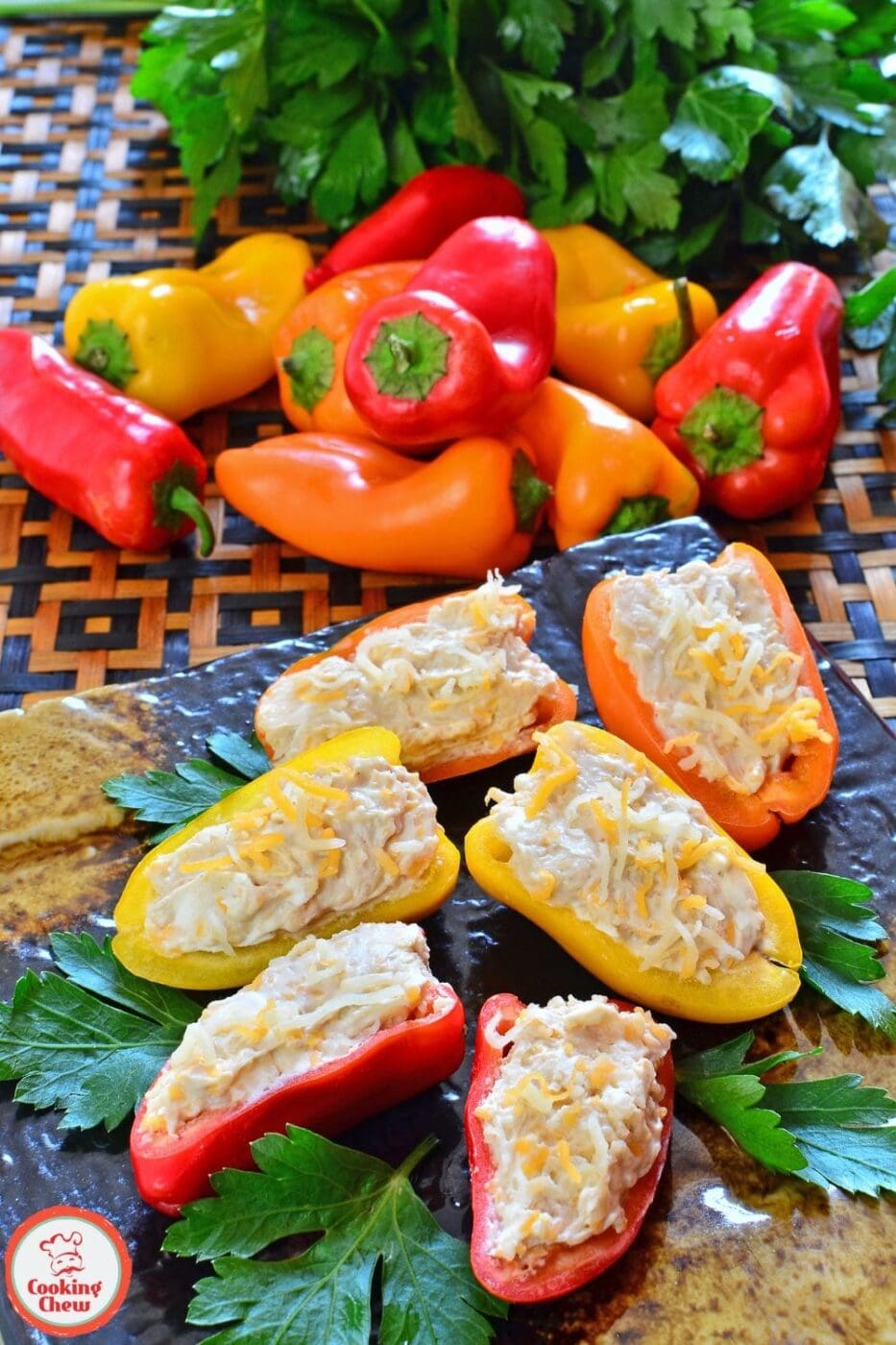 Colorful mini peppers stuffed with a cheesy filling, baked golden and served as an appetizer on a plate, perfect for healthy party snacks.