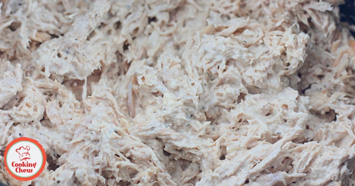 A warm bowl of creamy crack chicken served with crusty bread.