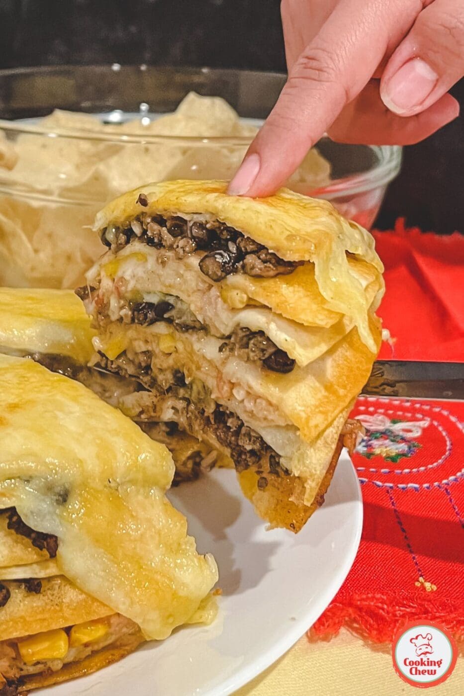 A delicious layered Mexican tortilla casserole topped with melted cheese and garnished with fresh cilantro, ready to serve.