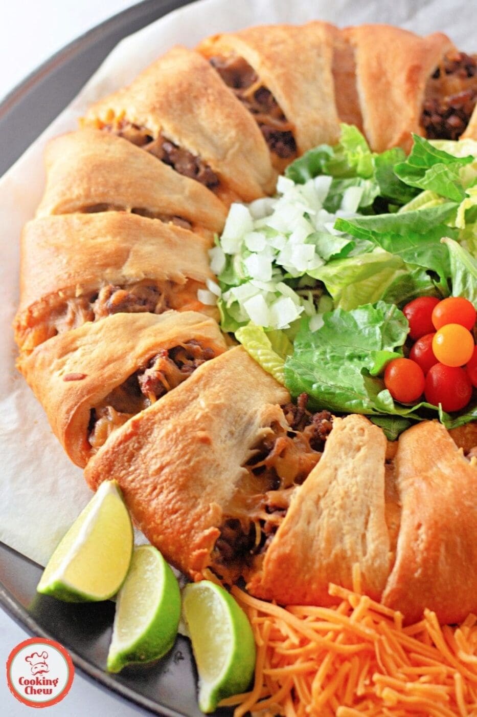 A golden-brown taco crescent roll ring filled with seasoned beef and melted cheese.