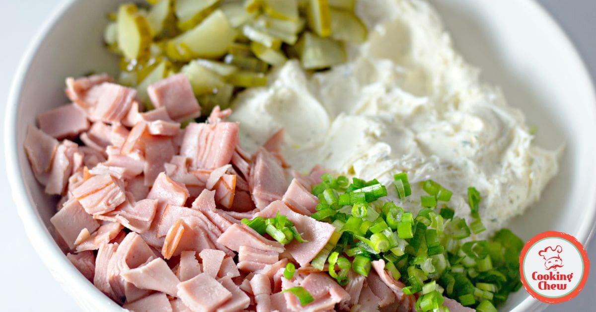 Dill pickle dip served with crackers and colorful veggies for a party.