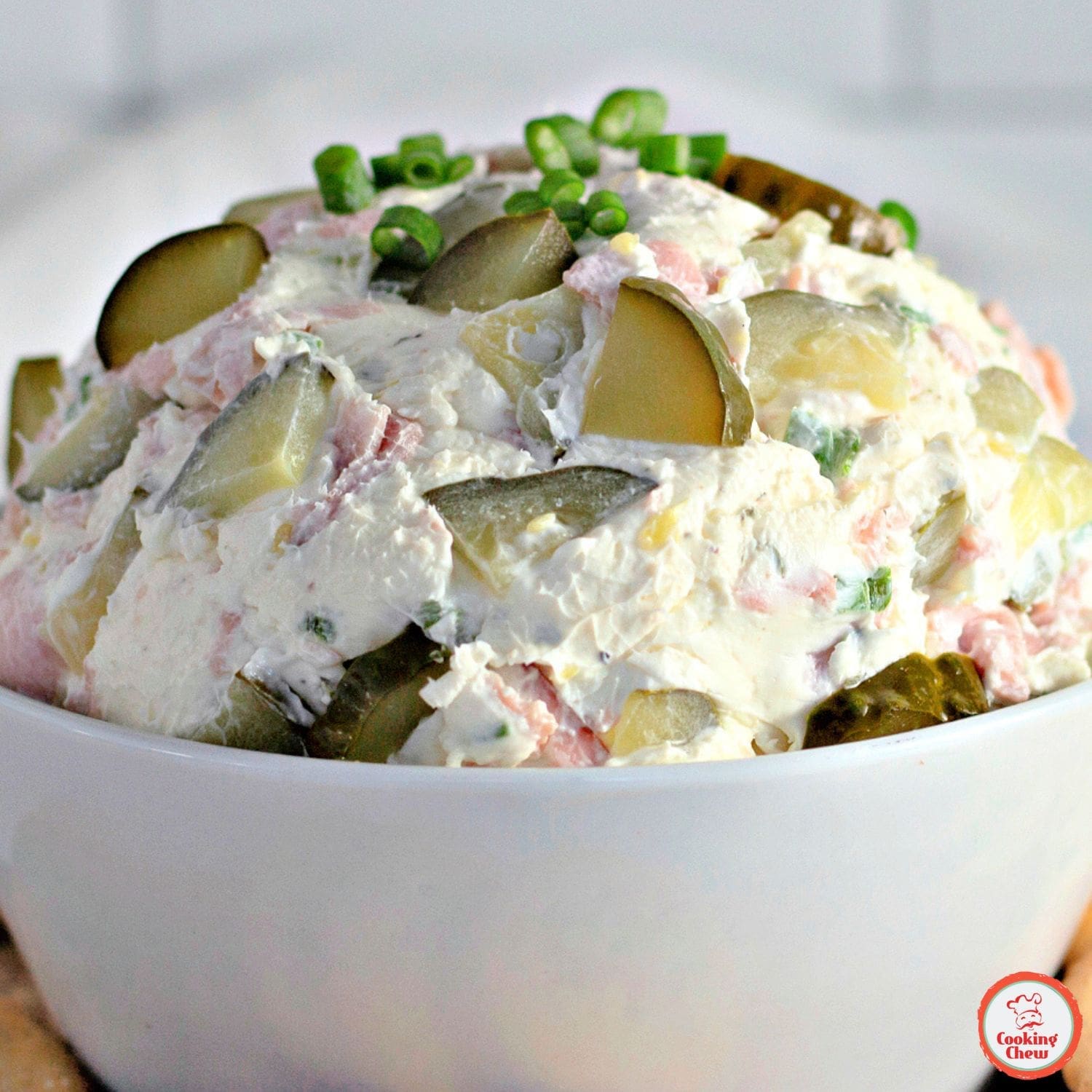 Close-up of creamy dill pickle dip garnished with chopped dill.