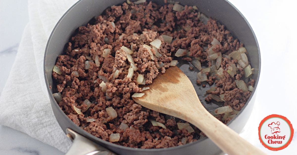 A Tex-Mex crescent ring with ground beef and melted cheese, garnished with fresh toppings.