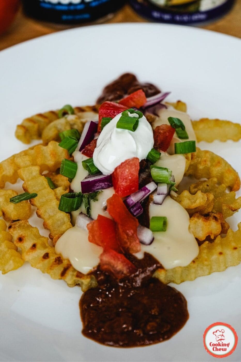 A plate of cheesy chili fries, piled high with hearty chili, melted cheese, and crispy fries &ndash; the ultimate comfort food.