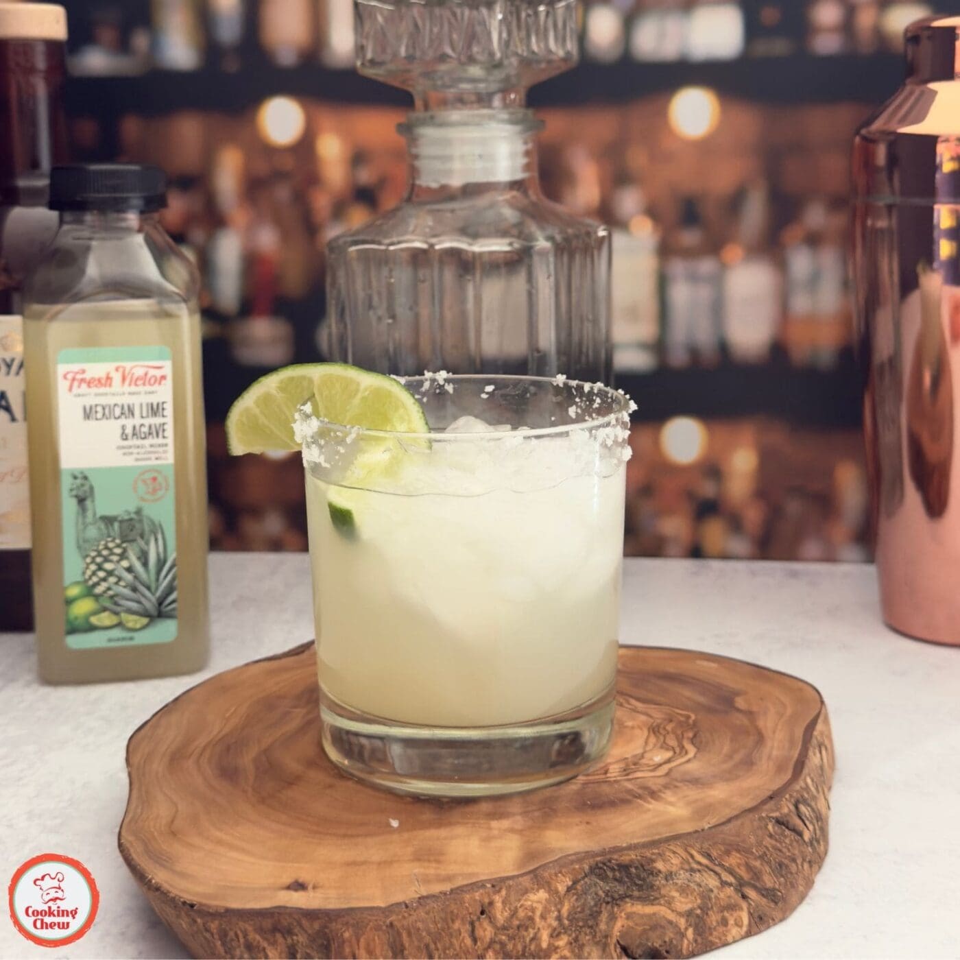 A chilled margarita on the rocks with a salted rim and lime garnish, ready to enjoy.