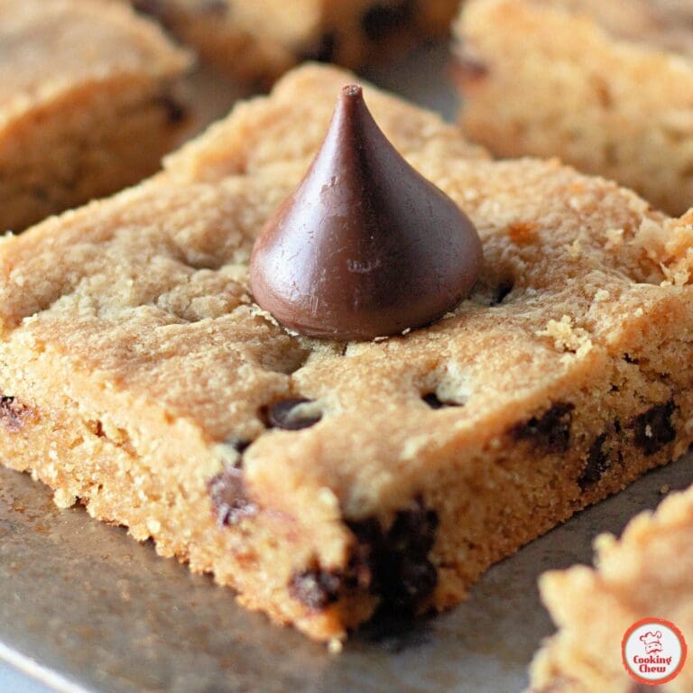 A stack of chewy peanut butter cookie bars on a cooling rack.