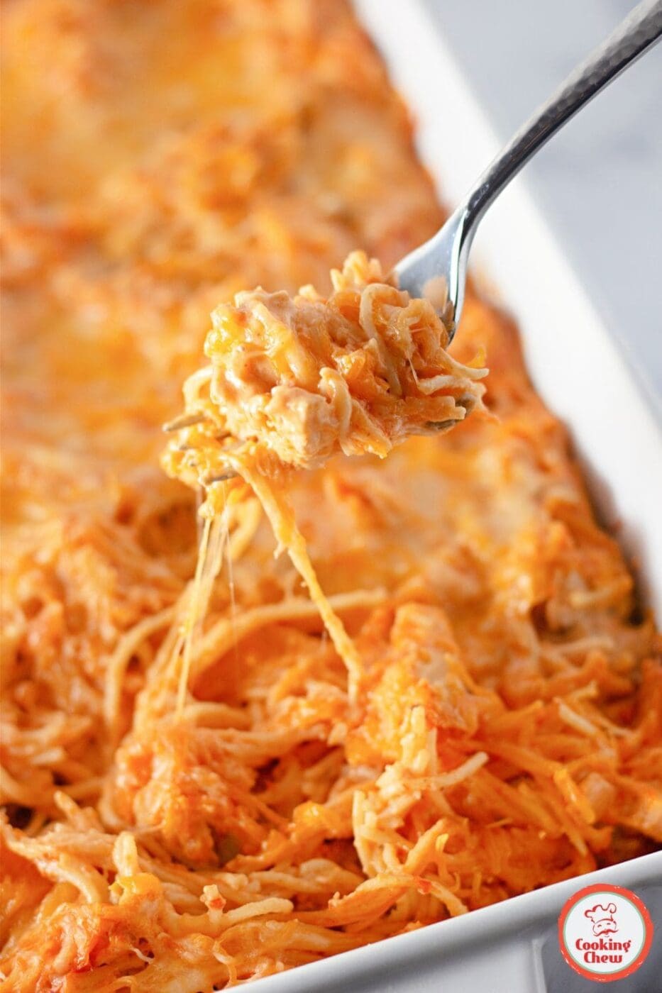 A hearty, cheesy chicken taco spaghetti topped with melted cheese and taco-seasoned chicken, a perfect Tex-Mex comfort food dish.