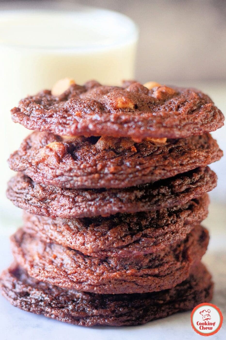 A stack of soft and chewy chocolate cookies with peanut butter chips, fresh out of the oven.