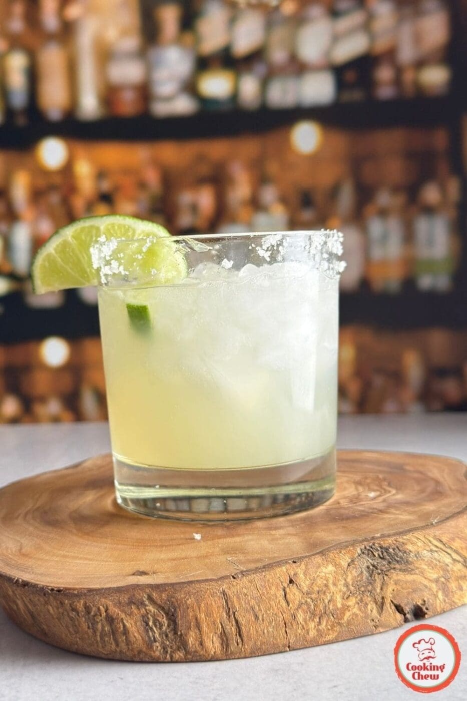 A refreshing classic margarita on the rocks with a salted rim and fresh lime garnish.