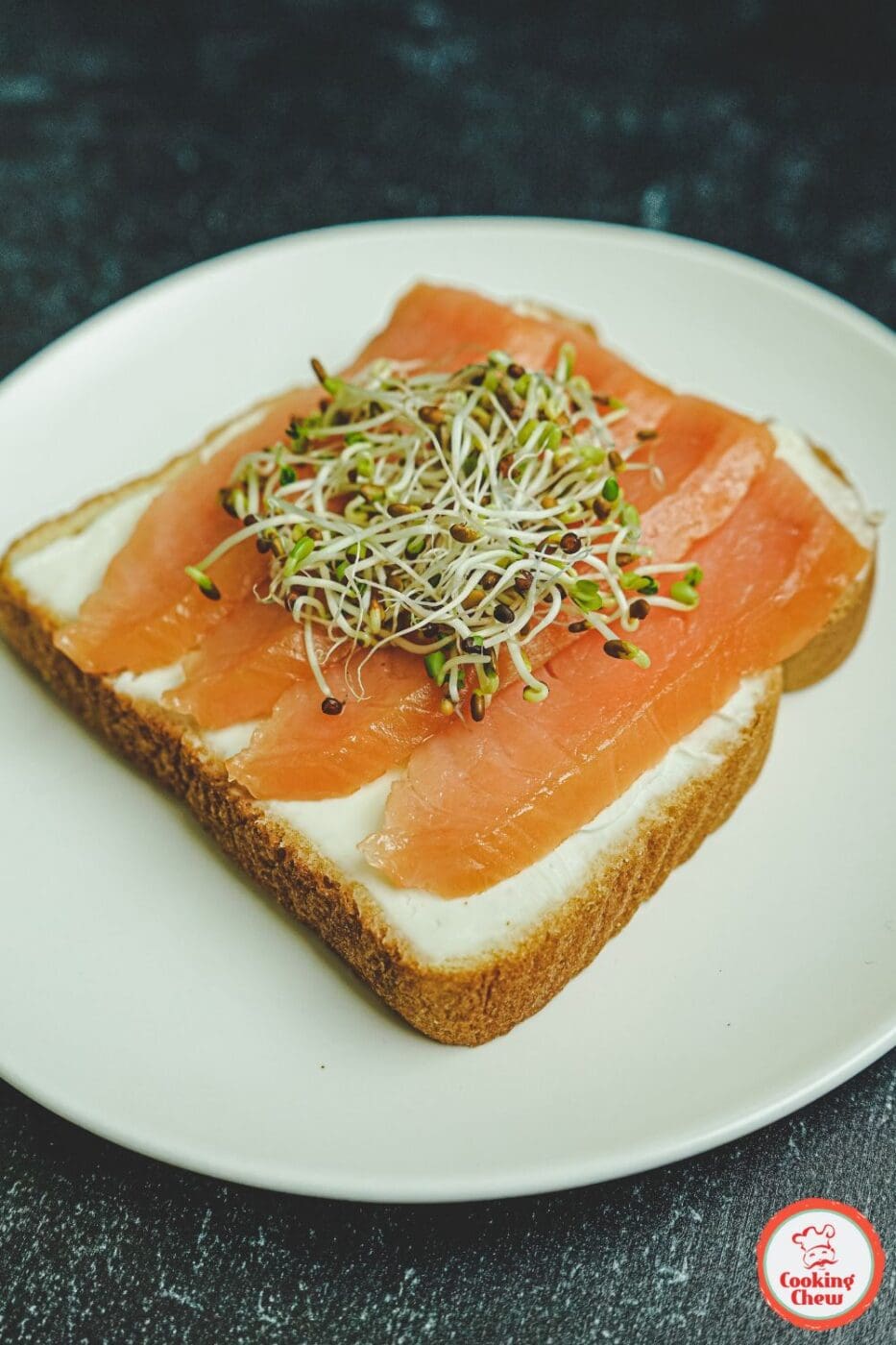 A beautifully plated cream cheese toast topped with fresh fruit, honey, and nuts for a delicious breakfast option.