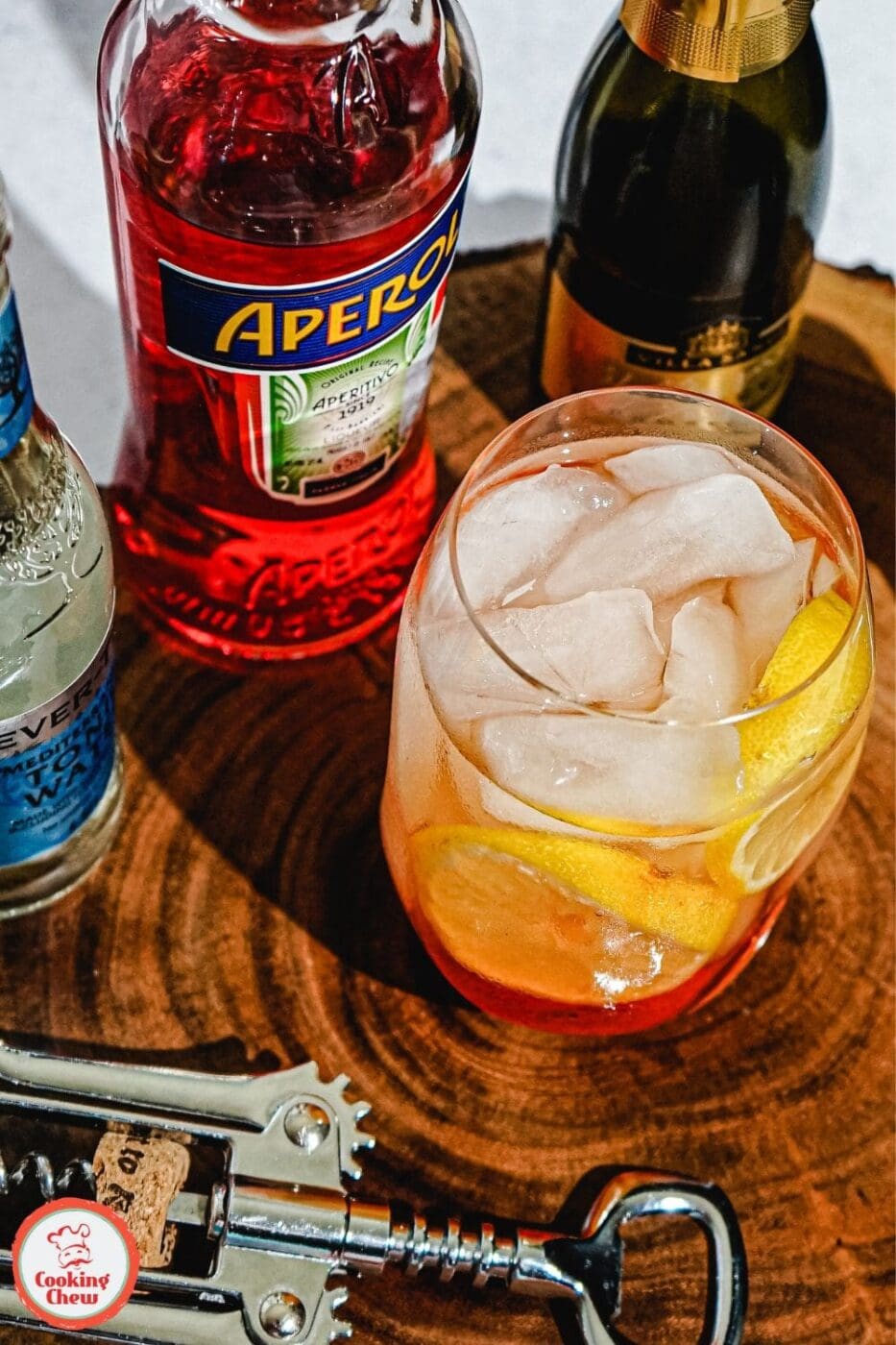 A vibrant Aperol Spritz cocktail in a glass with a bright orange hue, garnished with an orange slice, perfect for a summer evening.