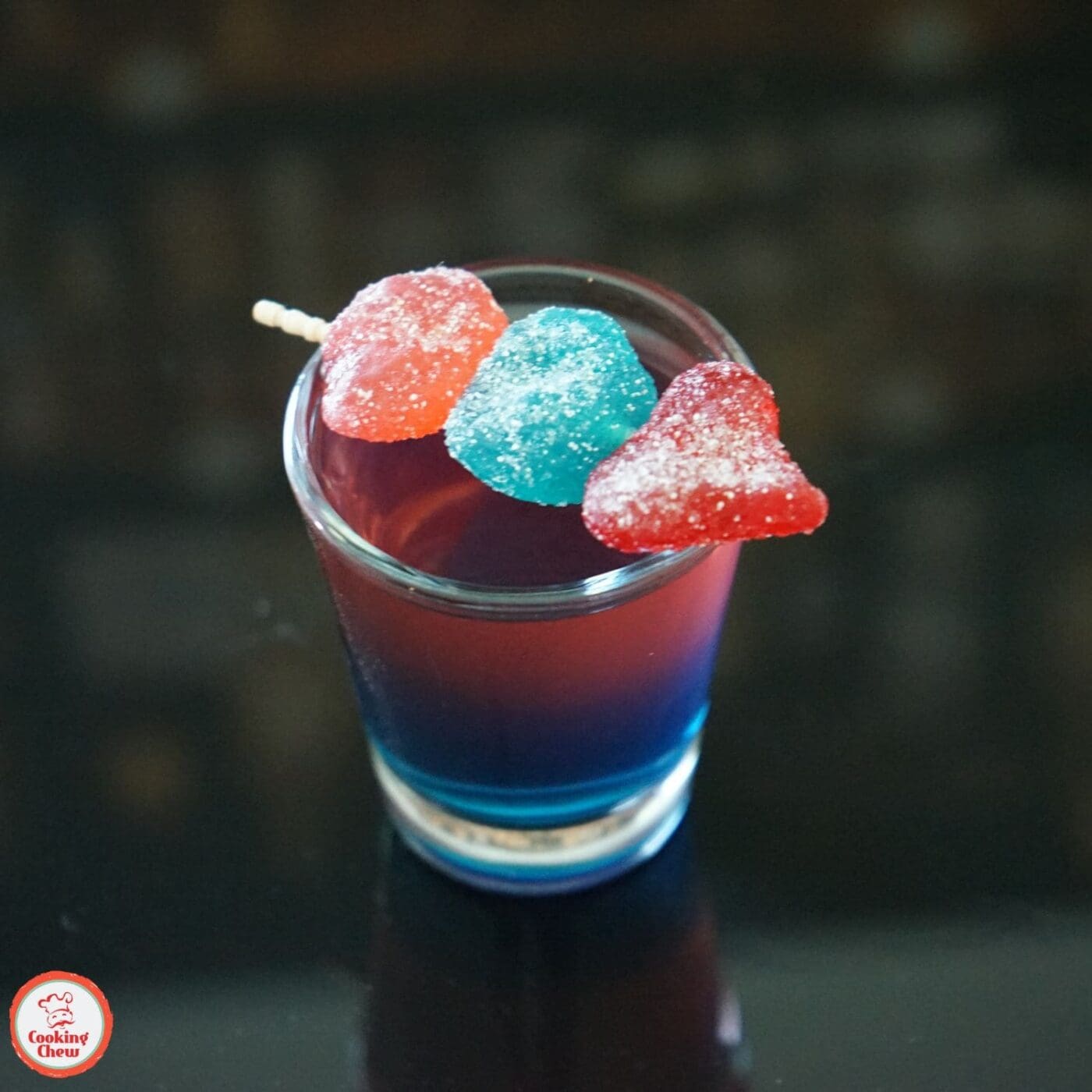 Bright and colorful layered Jolly Rancher shots, ready to enjoy at a party.