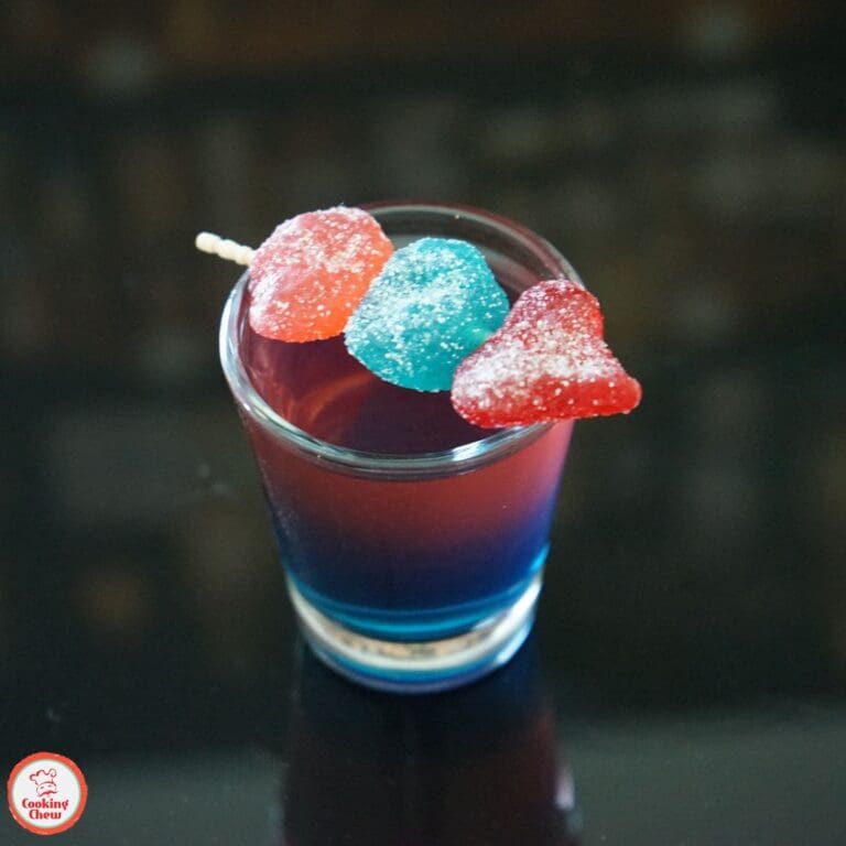 Bright and colorful layered Jolly Rancher shots, ready to enjoy at a party.