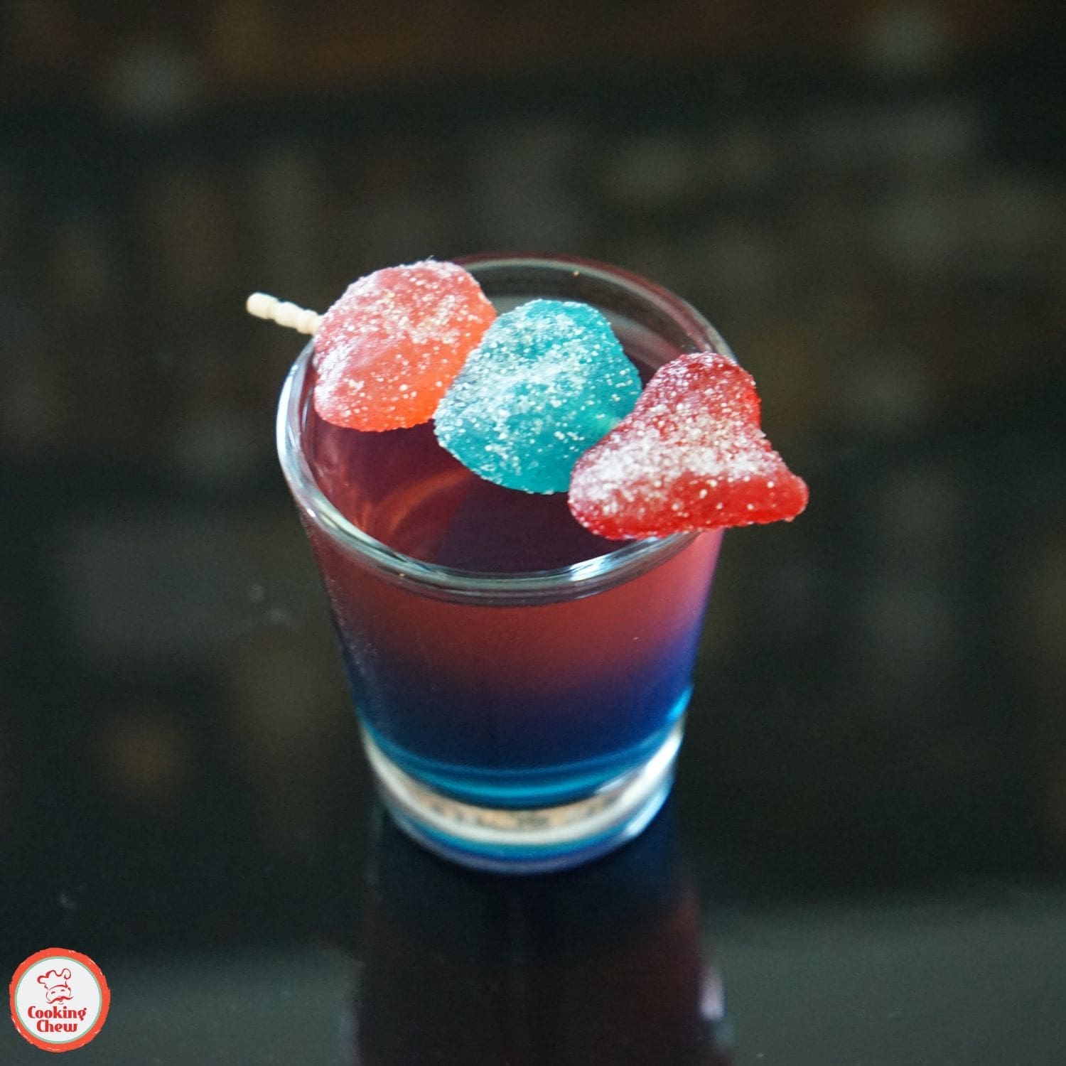 Bright and colorful layered Jolly Rancher shots, ready to enjoy at a party.