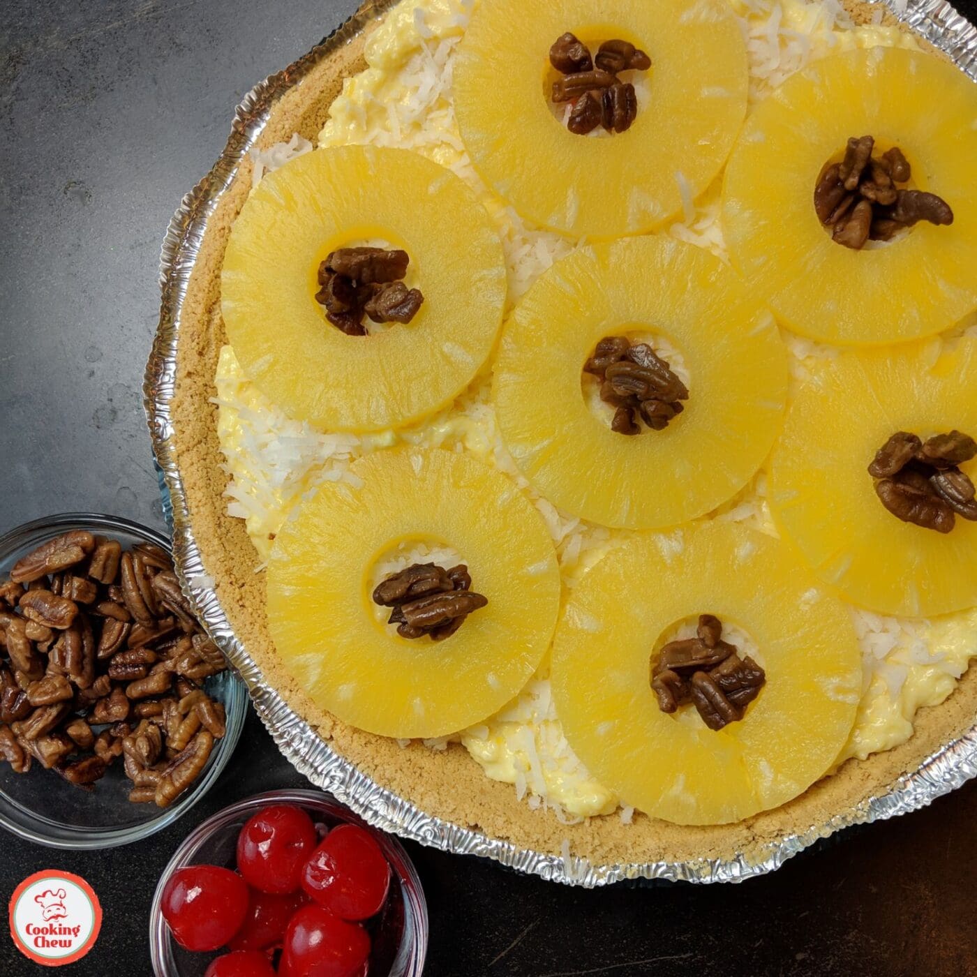 A slice of tropical fruit pie with a golden graham cracker crust.
